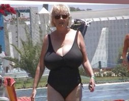 Blonde Slim and Busty Sexy Grandma in a Black Bathing Suit and Shades.jpg