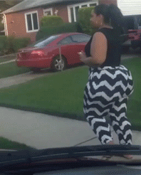 Black Lady with a Massive Booty in a Black Tanktop and Black and White Tights Walking on a Sid...gif