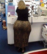 Blonde Lady in a Black Top and Big Brownish Skirt with a Massive Ass from Behind.jpg