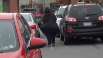 Brunette White Lady with Huge Massive Ass in a Black Top and Blue Pants Walking in Traffic Can...jpg