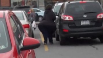 Brunette White Lady with Huge Massive Ass in a Black Top and Blue Pants Walking in Traffic Can...jpg
