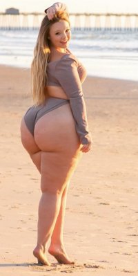Blonde Busty Big Booty Beauty in a Sexy Gray Bathing Suit Posing at the Beach in a Full Body f...jpg