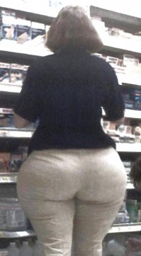 Brunette Lady in a Black Top and White Pants with a Huge Ass from Behind.jpg